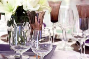 sophisticated tables with plates, cutlery and fine glasses close-up photo