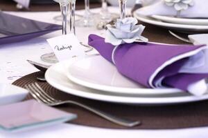 sophisticated tables with plates, cutlery and fine glasses close-up photo