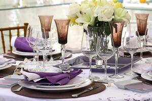 sophisticated tables with plates, cutlery and fine glasses close-up photo