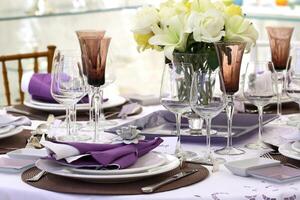 sophisticated tables with plates, cutlery and fine glasses close-up photo