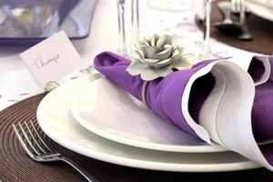 sophisticated tables with plates, cutlery and fine glasses close-up photo