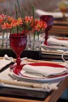 sophisticated table arrangements with red jackfruit glasses photo