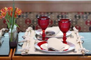 sophisticated table arrangements with red jackfruit glasses photo