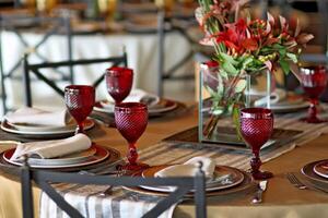 sophisticated table arrangements with red jackfruit glasses photo