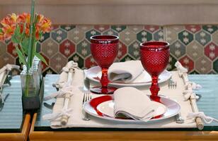 sophisticated table arrangements with red jackfruit glasses photo