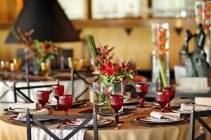 sophisticated table arrangements with red jackfruit glasses photo