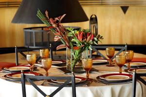 sophisticated table arrangements with red jackfruit glasses photo