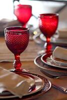 sophisticated table arrangements with red jackfruit glasses photo