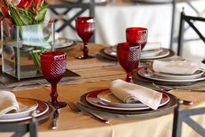 sophisticated table arrangements with red jackfruit glasses photo