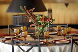 sophisticated table arrangements with yellow jackfruit glasses photo