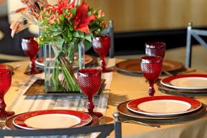 sophisticated table arrangements with red jackfruit glasses photo