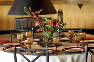 sophisticated table arrangements with yellow jackfruit glasses photo