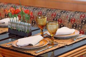 sophisticated table arrangements with yellow jackfruit glasses photo