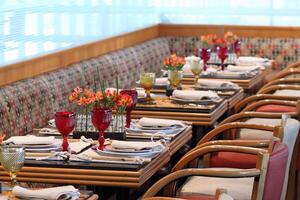 sophisticated table arrangements with red jackfruit glasses photo