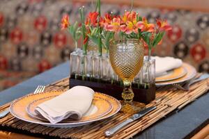 sophisticated table arrangements with yellow jackfruit glasses photo