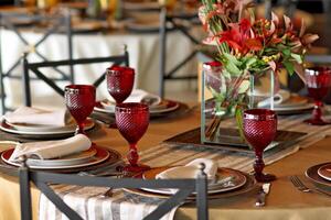 sophisticated table arrangements with red jackfruit glasses photo