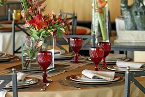 sophisticated table arrangements with red jackfruit glasses photo