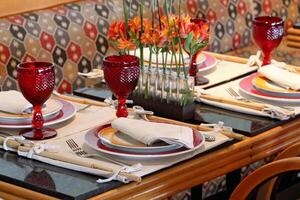 sophisticated table arrangements with red jackfruit glasses photo