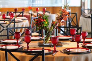 sophisticated table arrangements with red jackfruit glasses photo