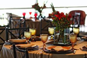 sophisticated table arrangements with yellow jackfruit glasses photo