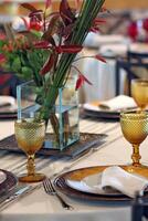 sophisticated table arrangements with yellow jackfruit glasses photo