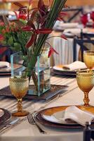 sophisticated table arrangements with yellow jackfruit glasses photo