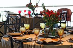 sophisticated table arrangements with yellow jackfruit glasses photo