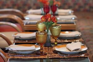 sophisticated table arrangements with yellow jackfruit glasses photo