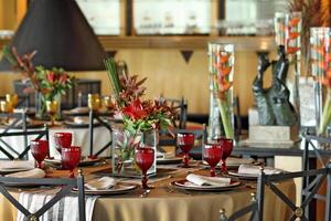 sophisticated table arrangements with red jackfruit glasses photo