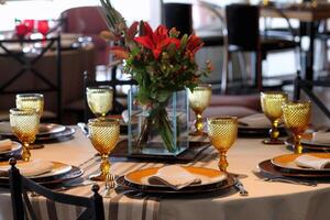 sophisticated table arrangements with yellow jackfruit glasses photo