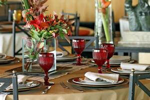 sophisticated table arrangements with red jackfruit glasses photo