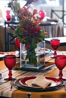 sophisticated table arrangements with red jackfruit glasses photo