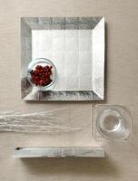 assembly of ceramic, wood and metal pieces with fruits on a fabric background photo