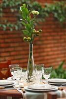 creative and informal table set up outside the house with all the details photo