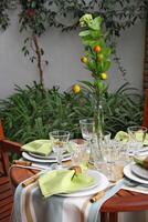 creative and informal table set up outside the house with all the details photo