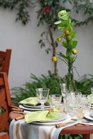 creative and informal table set up outside the house with all the details photo