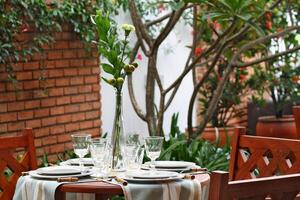 creative and informal table set up outside the house with all the details photo