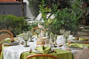 creative and informal table set up outside the house with all the details photo