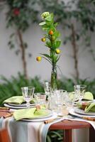 creative and informal table set up outside the house with all the details photo