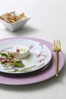 brie cheese and salad on beautiful plate with golden fork photo