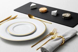 assembly of plates with golden cutlery and various types of cheese photo