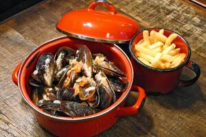 mussels in vinaigrette sauce in red pan photo