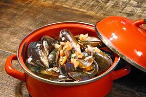 mussels in vinaigrette sauce in red pan photo