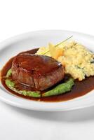 truffled medallion with brie cheese risotto and sauce photo