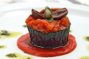 eggplant with anchovies and olives and tomato sauce photo