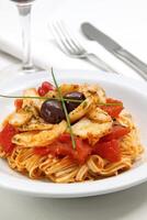 tagliatelle with cod chips on plate photo