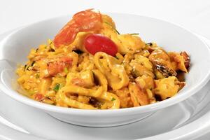 risotto al mare with squid and prawns in sauce photo