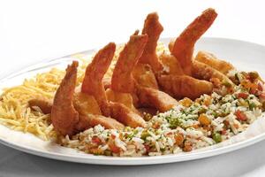 fried and breaded prawns with Greek rice photo