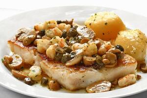 sea bass fish with shrimp and caper sauce photo
