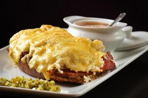 open pastrami sandwich on plate with gratin cheese and vinaigrette sauce photo